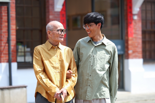 廖淵阿公與孫子一起拍照，留下美好回憶